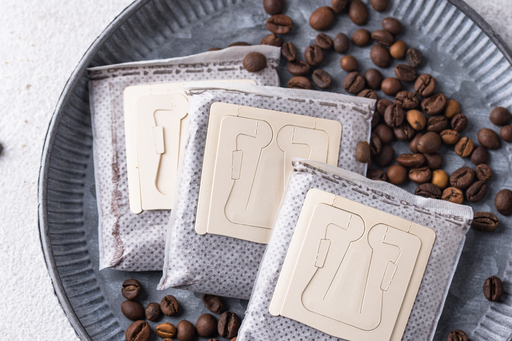 Wooden coasters with coffee bean design on a metal tray with coffee beans.